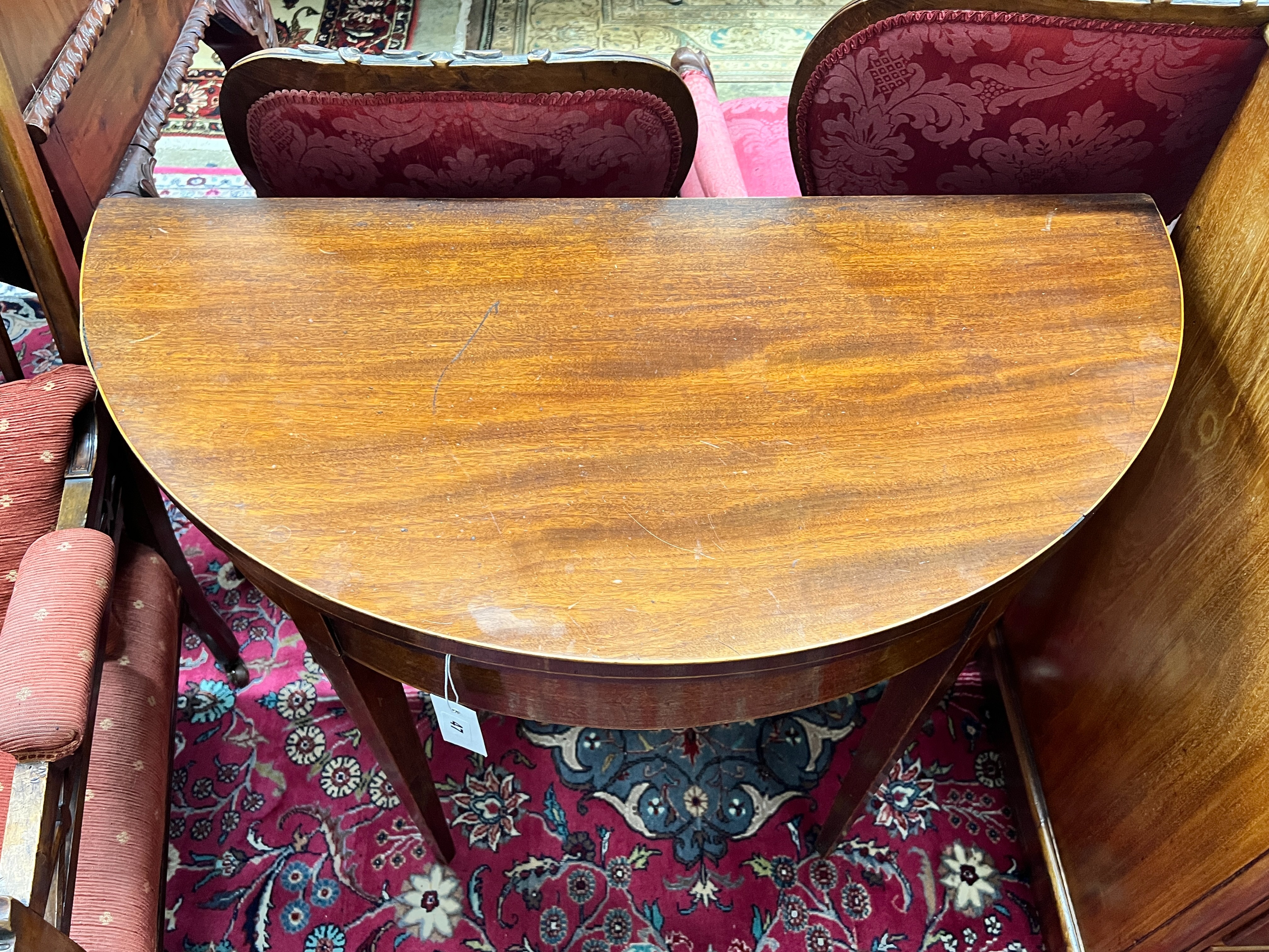 A George III mahogany D-shaped folding tea table, width 92cm, depth 46cm, height 73cm